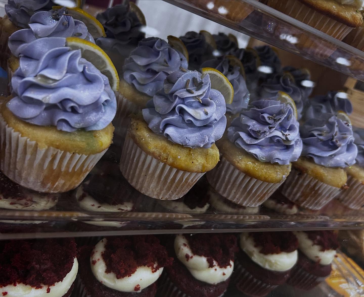 Tray of lavender frosted cupcakes with lemon slices